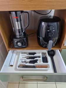 a drawer with a kitchen utensils and a blender at Apto no Centro de São Leopoldo in São Leopoldo