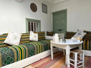 a living room with a couch and a table at Dar la famille Marrakech in Marrakech
