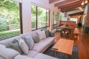 a living room with a couch and a table at Haus On Houghs in Bright