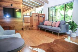 a living room with a couch and a tv at Haus On Houghs in Bright