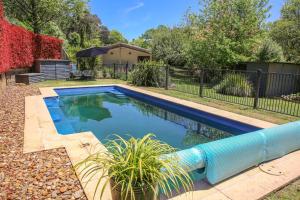 a swimming pool in a yard with a blue water slide at Haus On Houghs in Bright