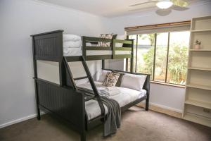 a room with two bunk beds and a couch at Haus On Houghs in Bright +33 photos