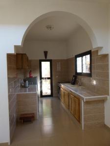 a kitchen with a sink and a counter in a room at Villa Dallie in Saly Portudal