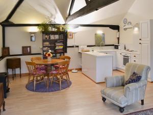 a kitchen and dining room with a table and chairs at Church Barn Studio in Brundall