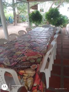 a long table with a table cloth on it at Mágica Cabaña familiar cerca al mar in Coveñas