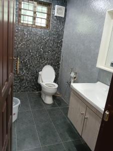 a bathroom with a toilet and a sink at Osama's Room for Rent in Murree +1 photo