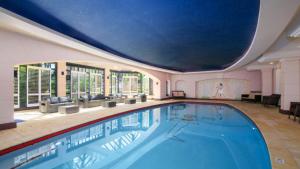 a large swimming pool with a large ceiling at Unit 42 - 2 Bedroom Garden View in Terrigal