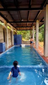 two people are in a swimming pool at Parijat-Breathtaking Sky and Hilltop view in Dapoli