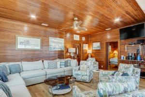 a living room with a white couch and chairs at DogFriendly Beachfront Condo in Fernandina Beach