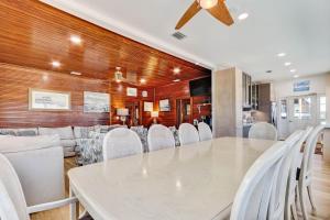 a dining room with a white table and white chairs at DogFriendly Beachfront Condo in Fernandina Beach +46 photos