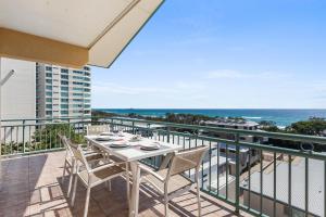 a balcony with a table and chairs and the ocean at Sunshine Towers Boutique Apartments in Maroochydore