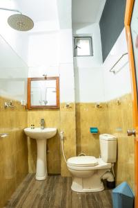 a bathroom with a toilet and a sink at 3 Arch Villa in Ella