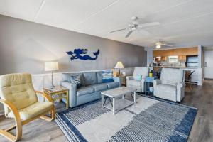 a living room with a couch and chairs and a table at Nautical Oceanfront Condo in Fernandina Beach