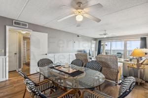 a living room with a glass table and chairs at Nautical Oceanfront Condo in Fernandina Beach