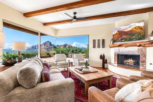 a living room with a couch and a fireplace at Sedona Luxury with 75’ Lap Pool, Hot Tub & Breathtaking Vortex Views in Sedona +72 photos