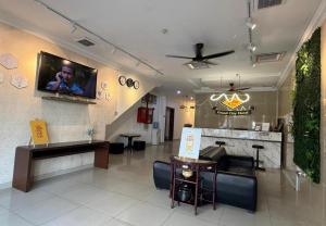 a waiting room with a tv on the wall at Grand City Hotel Kuantan in Kuantan