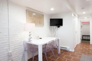 a white dining room with a white table and chairs at WELL-EQUIPPED STUDIO APT - WALK TO METRO SUBWAY in Washington, D.C.