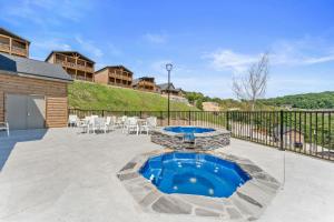 a patio with a pool and a table and chairs at Summertime Shores - 127 in Branson
