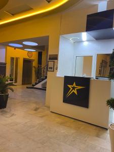 a lobby with a star sign on a wall at Hotel Golden Star in Taounate