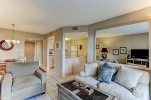 a living room with a couch and a tv at Beach Steps Away Condo in Fernandina Beach