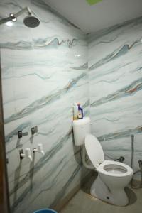 Un baño con un inodoro blanco en una habitación. en Homestay For Rent in Meerut, en Meerut