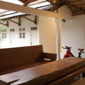 a room with a table and a bike in it at Cozy Corner House in Banyuwangi