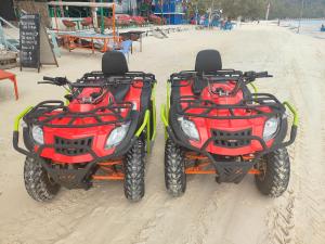 two atvs are parked on the beach at Sweet Time Bungalows in Koh Rong Sanloem