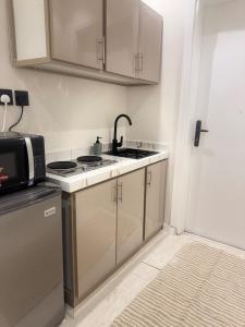 a kitchen with a sink and a microwave at Reefy studio 6 in Riyadh