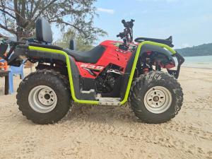a red and green atv parked on the beach at Sweet Time Bungalows in Koh Rong Sanloem