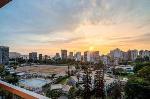 a view of a city skyline with the sun setting at Barranco Modern Apartments with Rooftop Pool by Geko in Lima +49 photos