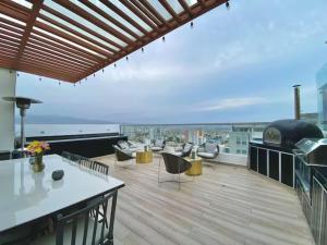 a balcony with a table and chairs on a building at Barranco Modern Apartments with Rooftop Pool by Geko in Lima