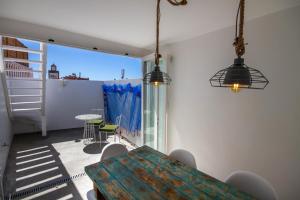 a dining room with a table and a balcony at Dar Ferran in Essaouira +49 photos