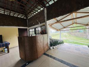 a room with a large wooden door in a building at Camp Rhino Resort Kaziranga in Kuthari