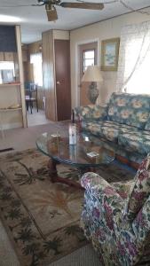 a living room with a couch and a glass table at 3 BR home on a canal in Paradise near the Beach! in Englewood