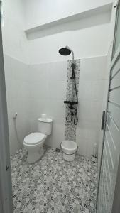 a bathroom with a toilet and a sink in it at Sultan Agung Homestay Syariah in Magelang +18 photos