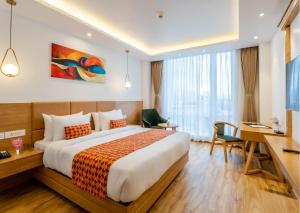 A bed or beds in a room at Hotel Anuttara