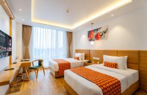 A bed or beds in a room at Hotel Anuttara