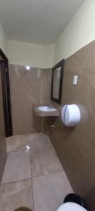 a bathroom with a sink and a mirror at Hotel TINAMIT in San Pedro La Laguna