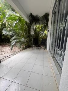 a porch of a house with a tile floor at Appartement Baobab 2 in Pereybere