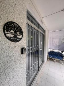 a door to a balcony with a bench outside at Appartement Baobab 2 in Pereybere