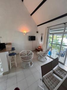 a living room with a couch and chairs and a table at Baobab 3 Apartment in Grand-Baie