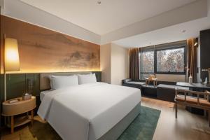 Voodi või voodid majutusasutuse JINGCADIA Hotel Nanjing Confucius Temple toas