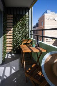 a balcony with a wooden table and chairs on a roof at Lovely Nest - Goeppingen City, Kitchen, Parking, Up to 4 People in Göppingen
