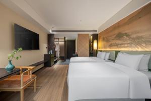Voodi või voodid majutusasutuse JINGCADIA Hotel Nanjing Confucius Temple toas