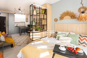 a living room with a bed and a kitchen at Boho apartment studio in Batumi