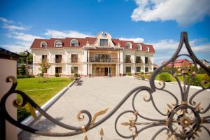 a large building with a gate in front of it at Imperator Hotel in Tula