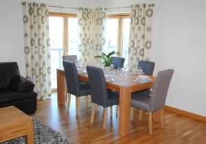 a dining room with a wooden table and chairs at Executive 3 Bed Apartment Aberdeen in Aberdeen