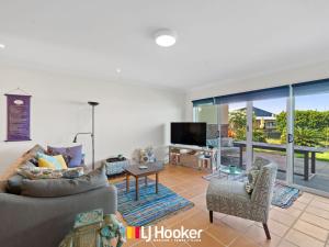 a living room with a couch and chairs and a television at Riverview Apartment 1.2 in Iluka