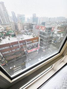 a view of a city from a window at 2519#Gangnam Urban Vogue Suites #Top-rated Unit # All-New Furniture & Peaceful Vibe#Sinnonhyeon 1min in Seoul