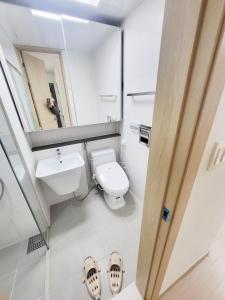 a bathroom with a toilet and a sink and a mirror at 2519#Gangnam Urban Vogue Suites #Top-rated Unit # All-New Furniture & Peaceful Vibe#Sinnonhyeon 1min in Seoul